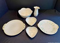 Full view of all six Belleek porcelain pieces showing shape and decoration.