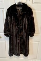 Front view of full length dark ranch mink fur coat on hanger highlighting the collar and cuffs.