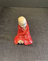 Front view of the Royal Doulton porcelain figurine of a child in red robe