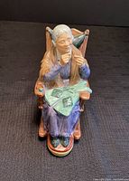 Front view of the Royal Doulton figurine showing the elderly woman knitting as she sits in a rocking chair.