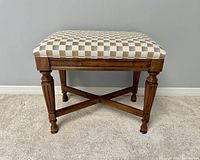 Front view of Drexel solid wood bench with upholstered checked seat cushion.