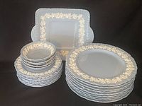 Overall view of entire lot with dinner plates, bread plates and serving dishes arranged.