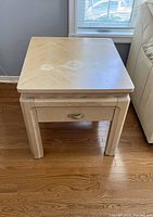 Top view of the square wood end table showing veneer pattern and wear spots.