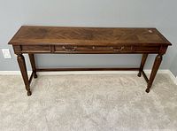 Front view of Drexel solid wood and veneer top sofa table showing drawer and leg details.