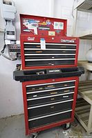 Full view of red rolling tool chest with top chest closed