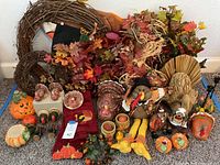 Photo of full assortment including wreaths, ceramic turkeys and pumpkins, fabric turkey doll, hand towels, and candlesticks.