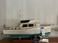 Side view of full scale model mounted on stand with US flag at stern