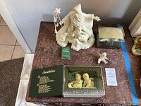 Overall view of Jack Frost figurine, small Snowbaby, boxed Snowbabies, and box with ornament parts