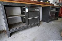 Two Craftsman workbench cabinets side by side under wood countertop