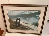 Framed limited edition print showing a detailed painting or print of a Vancouver Island marmot with mountainous background, matted and framed in wood with gold edge.
