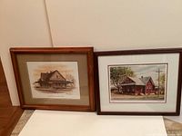 Photo shows two framed limited edition prints by Ross Logan of the Tillsonburg Train Station, one in sepia tone and one in color.