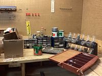 Photo of workbench with various storage units containing screws, nails, and small hardware parts