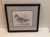 Framed and matted original pencil sketch artwork showing a finely detailed duck with natural background elements.