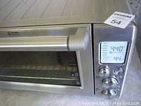 Close-up of Breville oven floor showing control panel, digital display, and handle in brushed stainless steel.