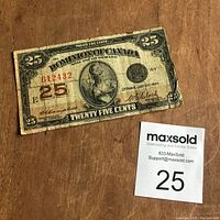 Front side of 1922 Canadian 25 cent shinplaster banknote displaying denomination, portrait, signatures, serial number, and wear.