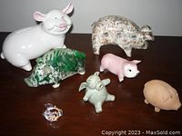 All 7 pigs together showing variety of styles and colors