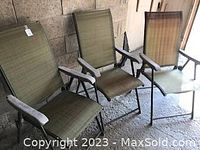 Three brown folding lawn chairs grouped together showing their overall condition and style.
