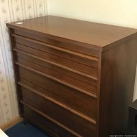 Angled front view showing flush drawer fronts and walnut finish