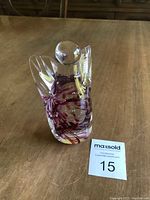 Front view of Shirley Elford glass angel showing clear glass with purple swirls and bubble inclusions.