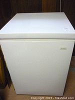 Front view of closed freezer showing white metal exterior and Coldspot badge
