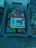 Photo of a plastic bin containing assorted Pokémon trading cards and related packaging material
