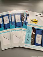 Three packages of Post-it Dry Erase Sheets in unopened packaging showing front design and branding.