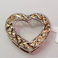 Front view of a heart-shaped 10K yellow gold pendant showing detailed cut-out pattern and beaded edges.
