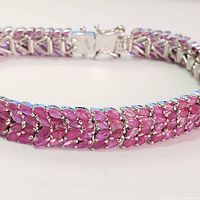 Close-up of the ruby stones and silver setting on the bracelet showcasing the marquise-cut stones and their arrangement in rows.