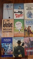 Books laid out showing covers including Doctor's Orders, Slaughterhouse Five, Fifth Business, The Inheritors, Soups and Soupheria, A Love Story, The Weirdstone of Brisingamen, A Fine and Private Place, The Horsemasters.