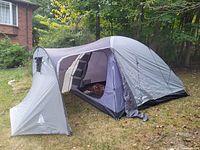 Woods Frontier 5 tent fully set up outside showing front canopy entrance and side view of tent body