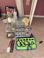 Overview of the jewelry making supplies, tools, trays, and packaged findings including wire spool and assorted beads