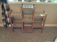Full frontal view of the wood plant stand showing its slatted shelf structure and dimensions.