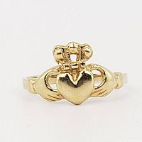 Front view of 10K gold Claddagh ring on white background