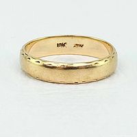 Front view of the 10K gold band showing the notched pattern and interior stamp