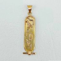 Front view of pendant showing hieroglyphic design
