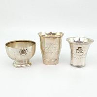 Three silver cups in a row, front view