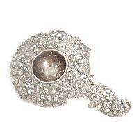 Full view of ornate sterling silver tea strainer