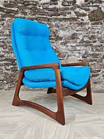 Front left three-quarter view of walnut frame and blue upholstered cushions