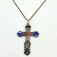 Close-up front image of Russian silver Orthodox cross pendant showing blue, red, black, and silver enamel with chain