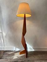 Full straight-on view of the lit lamp showing entire height and shade.