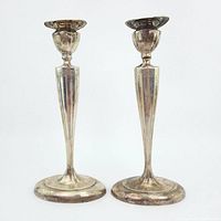 Front view of both candlesticks showing overall shape and condition