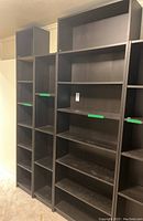 Three IKEA Billy bookcases side by side showing various shelf heights and widths.