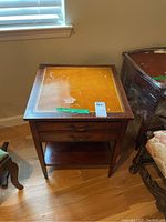 Full view of the mahogany side table with two drawers and bottom shelf, showing overall shape and design.