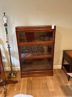 Full frontal view of three-tier oak barrister bookcase with drawer at base