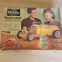 Top view of the original box with vintage artwork showing a yellow Classic '32 Ford Roadster and two people looking at the model car.