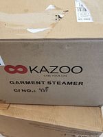 Box showing Kazoo Garment Steamer branding.