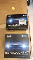 Two LED Headlight Kit boxes from SeaLight brand, one unopened and one opened, clearly showing product labels and branding.