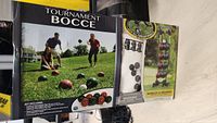 Box front showing EastPoint Tournament Bocce branding and image of the set being played outdoors with bocce balls and jack on grass.