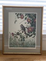 Framed print showing a bird on a flowering branch with detailed leaves and grass beneath, overall visible size about 21.5 x 26 inches.