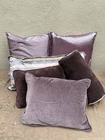 Full view of all six cushions stacked together showing fabric textures and colors